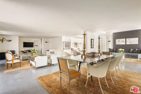 a dining room with furniture and wooden floor