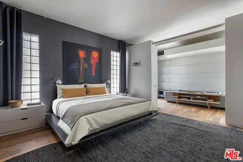 a bedroom with a bed and a television