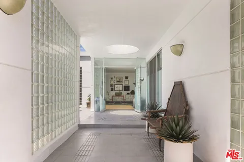 a view of a hallway to a livingroom with furniture