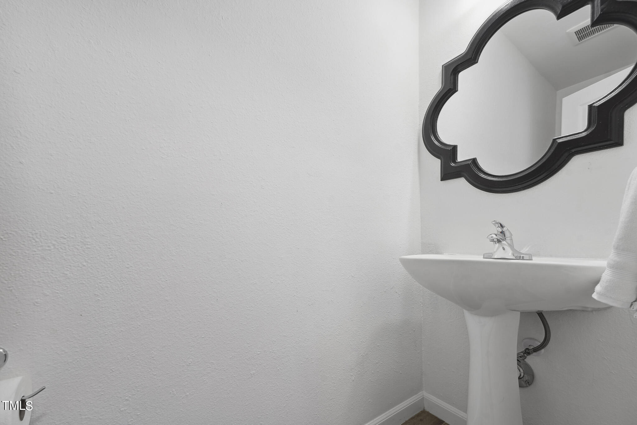 6320 Tryon Road Cary, NC 27518 - Photo 13 of 30 a bathroom with a sink and a mirror