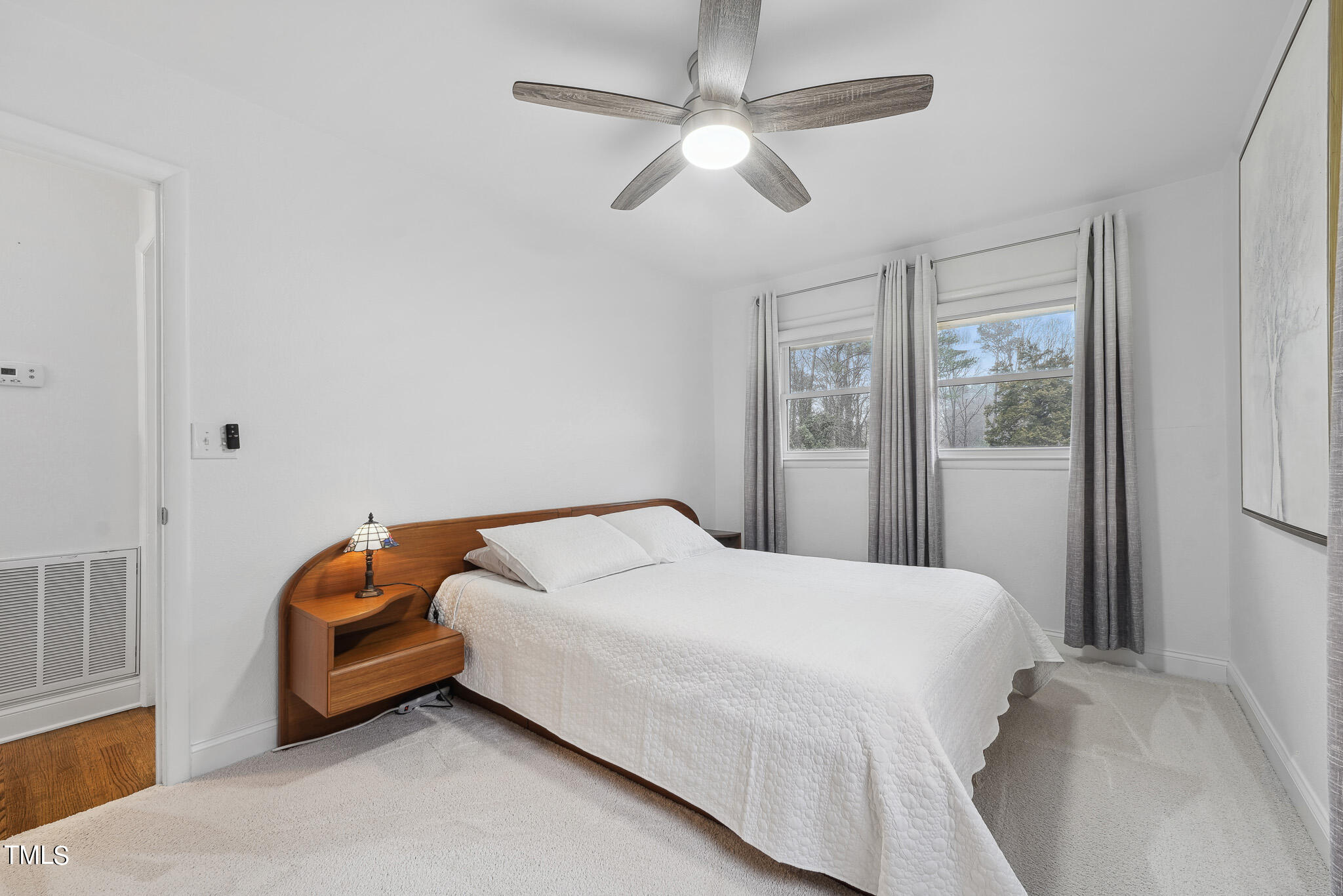 6320 Tryon Road Cary, NC 27518 - Photo 15 of 30 a bedroom with a bed ceiling fan and a window