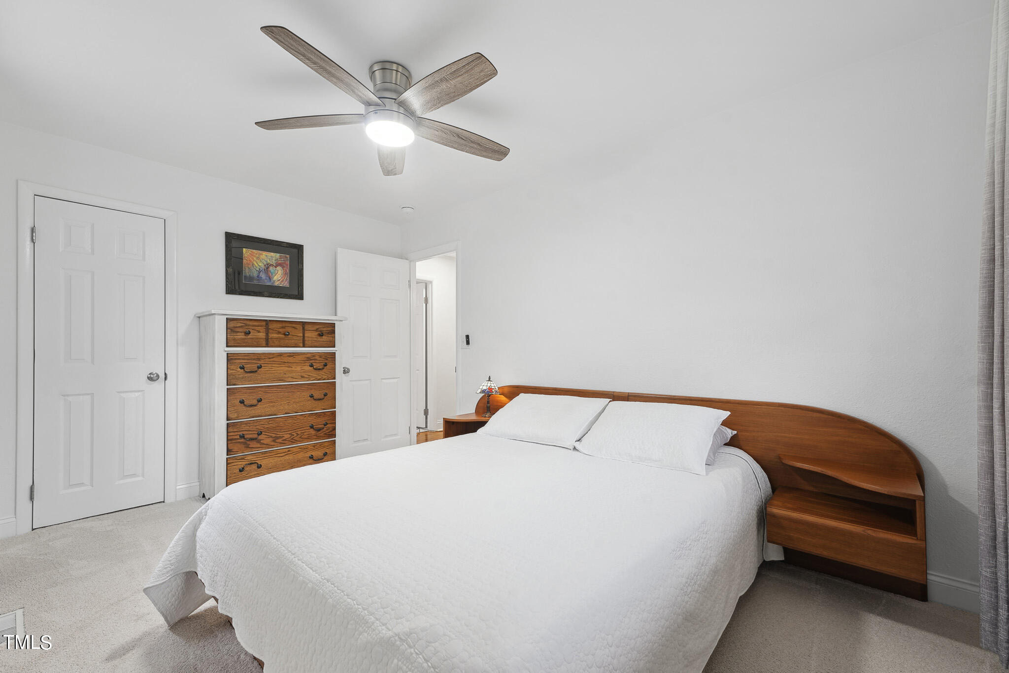 6320 Tryon Road Cary, NC 27518 - Photo 16 of 30 a bedroom with a bed and dresser