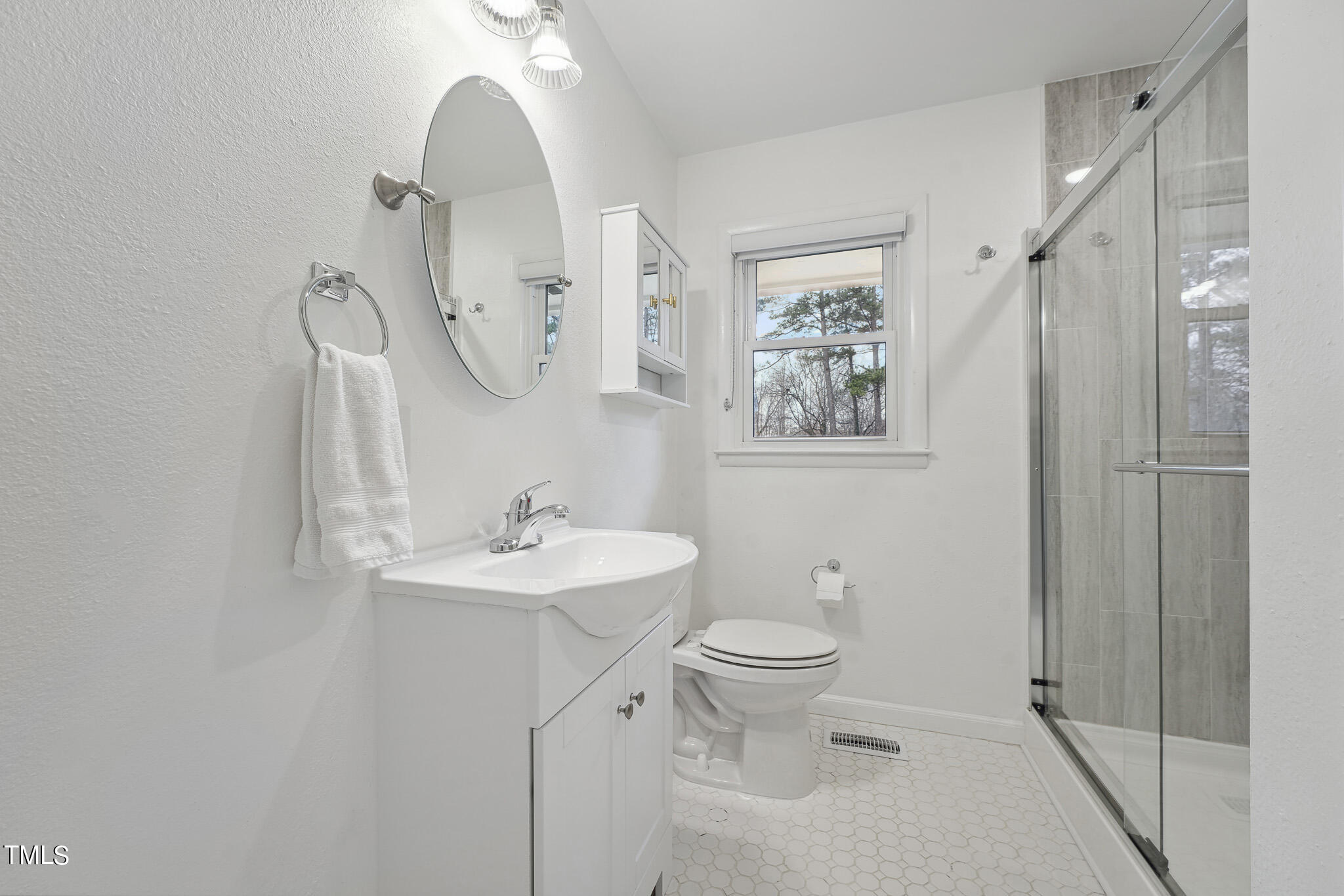 6320 Tryon Road Cary, NC 27518 - Photo 17 of 30 a bathroom with a toilet sink and mirror