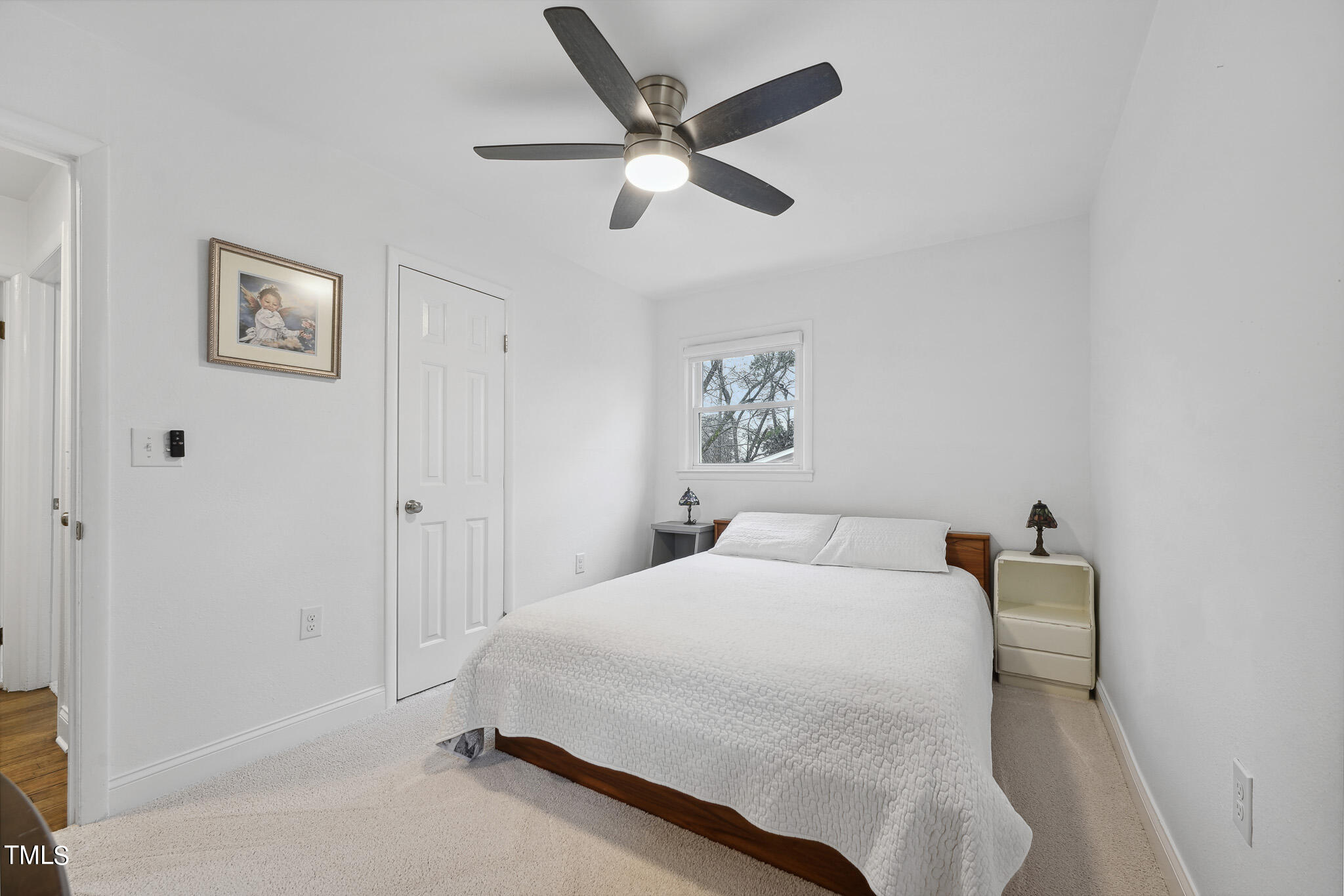 6320 Tryon Road Cary, NC 27518 - Photo 19 of 30 a bedroom with a bed and a ceiling fan