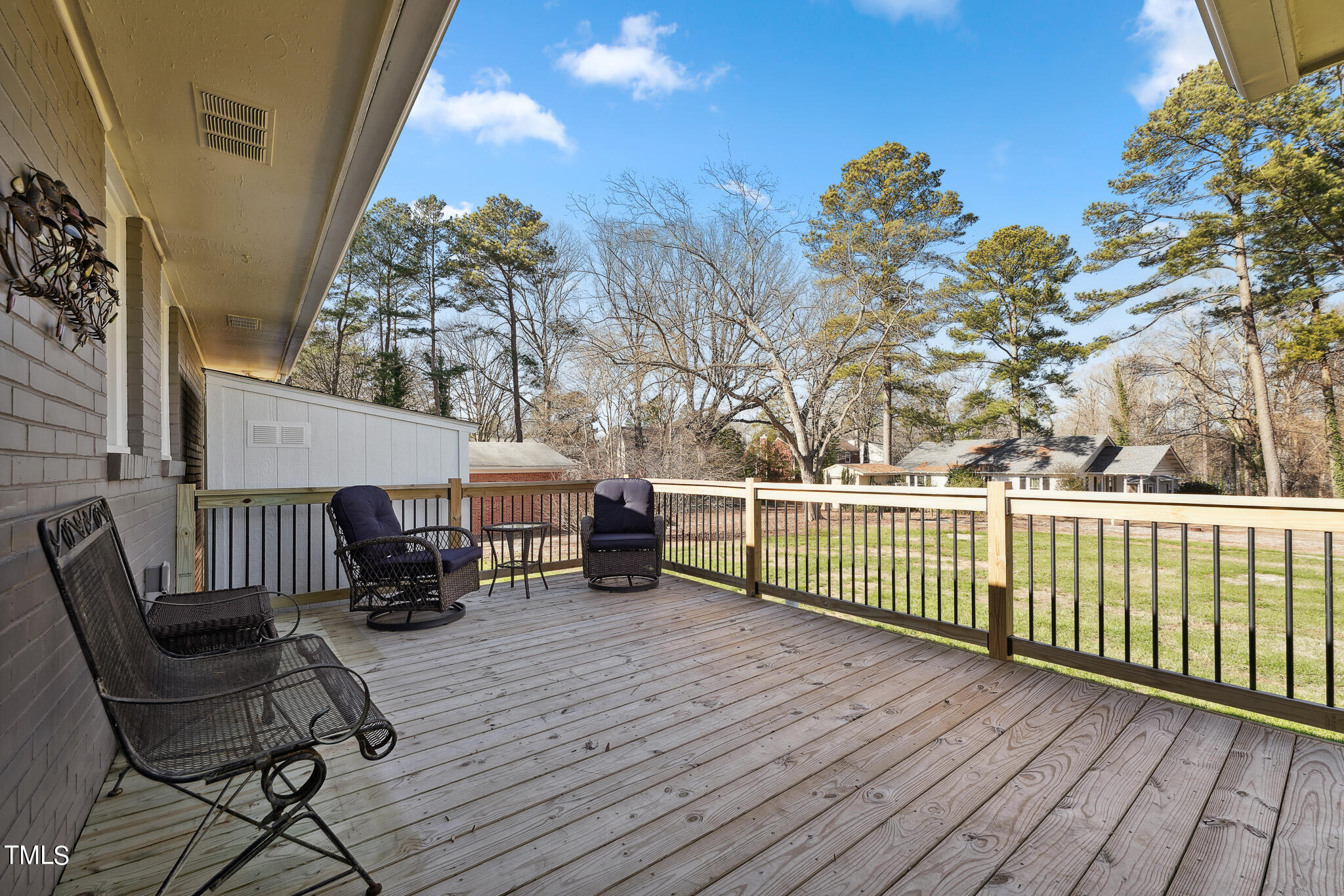 6320 Tryon Road Cary, NC 27518 - Photo 26 of 30 a view of a chair and tables on the wooden deck