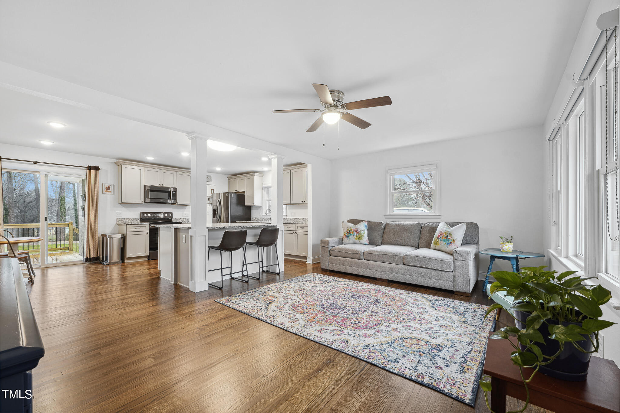 6320 Tryon Road Cary, NC 27518 - Photo 5 of 30 a living room with furniture kitchen view and a wooden floor