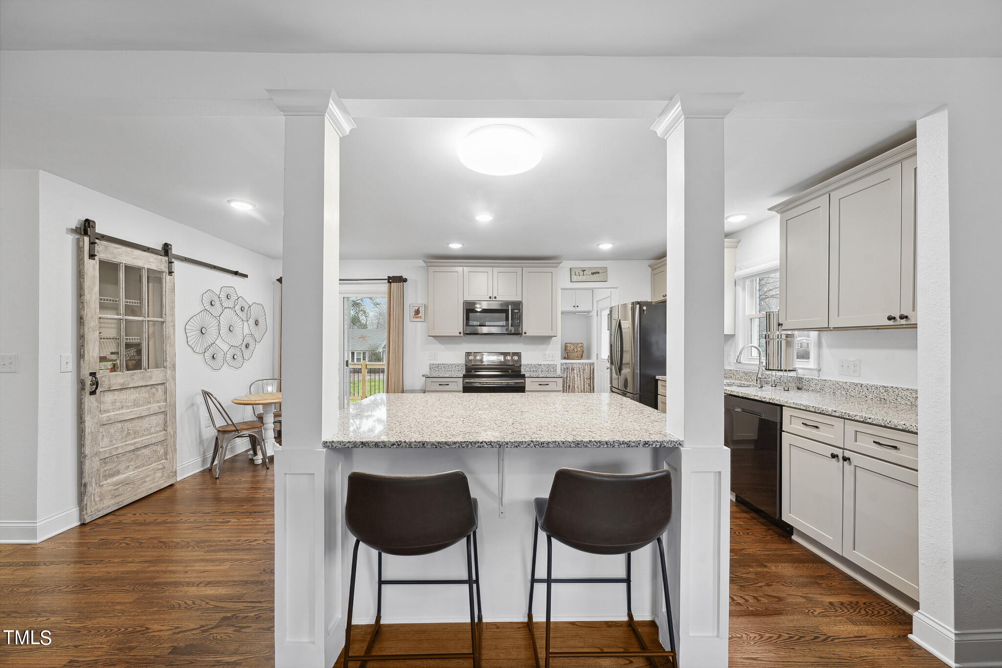 6320 Tryon Road Cary, NC 27518 - Photo 6 of 30 a large kitchen with kitchen island granite countertop a counter top space and cabinets