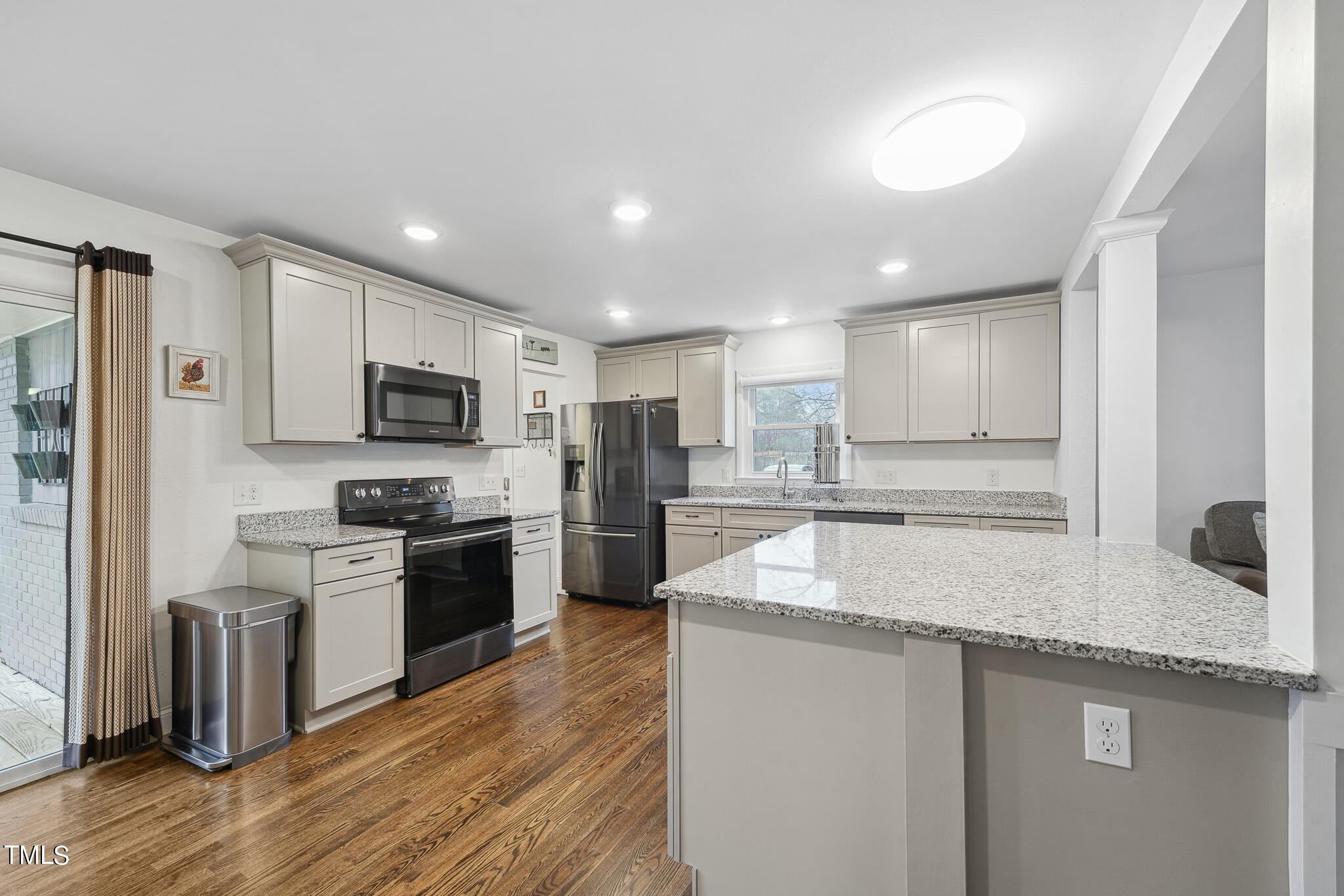 6320 Tryon Road Cary, NC 27518 - Photo 7 of 30 a kitchen with stainless steel appliances granite countertop a sink stove microwave and refrigerator