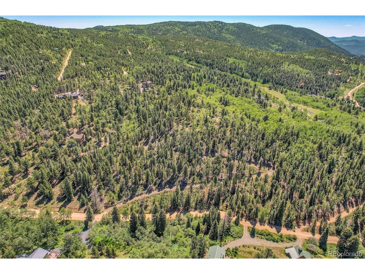 9 Hughesville Road Black Hawk, CO 80422 - Photo 2 of 17 a view of a lush green hillside and a mountain