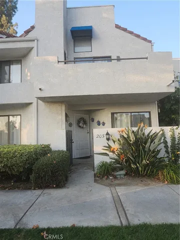 a bedroom with a bed and a large mirror on the dresser