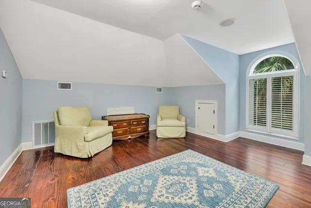 a bathroom with a toilet a sink a mirror and vanity