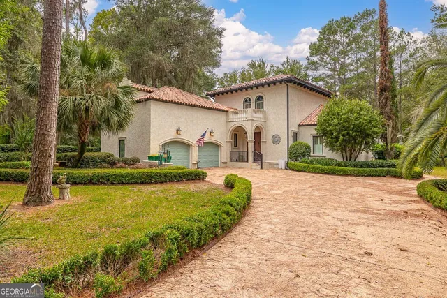 a view of a backyard with plants and trees