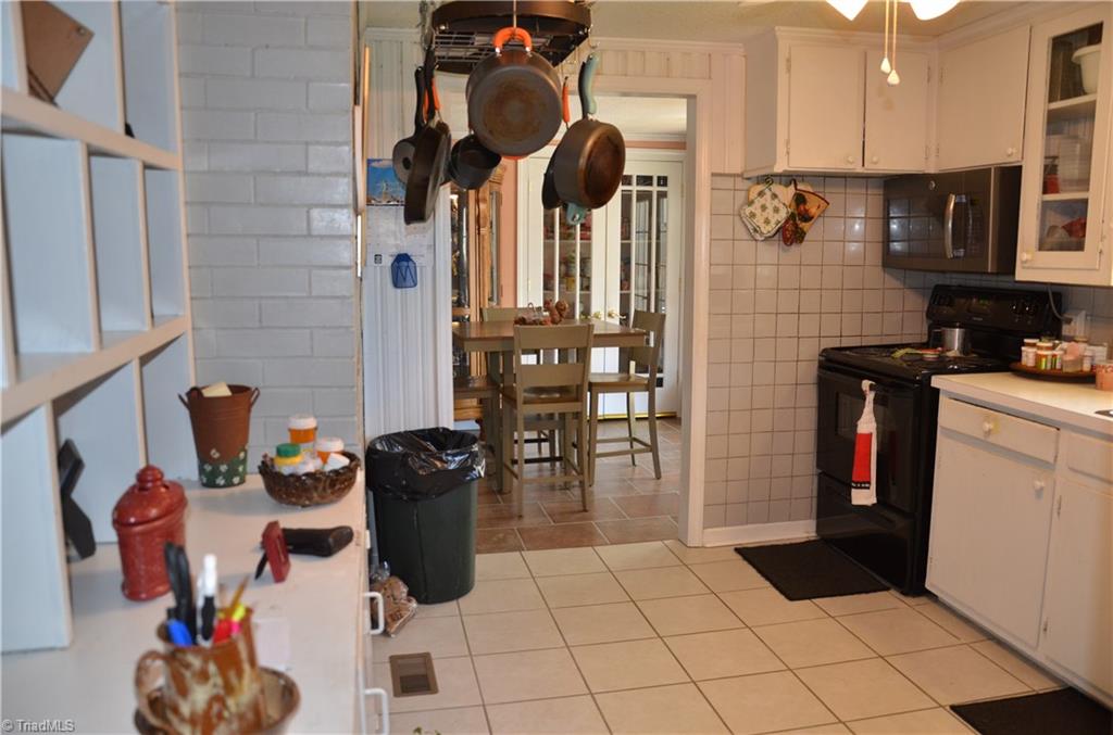 1631 Sexton Road Denton, NC 27239 - Photo 10 of 15 Kitchen with Updated Appliances, Tile Flooring, and Freshly Painted Cabinets.