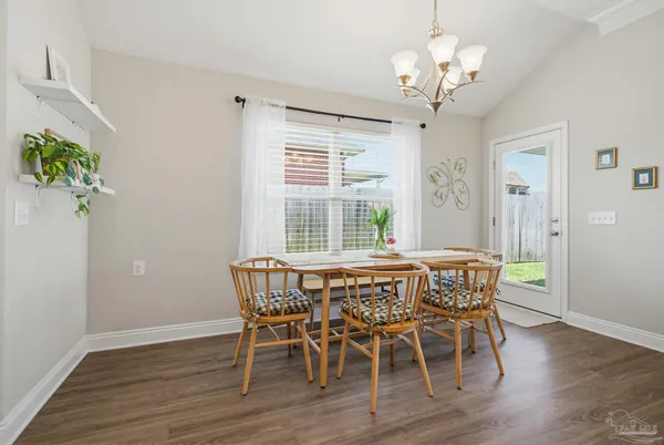 a view of a dining room with furniture wooden floor and chandelier