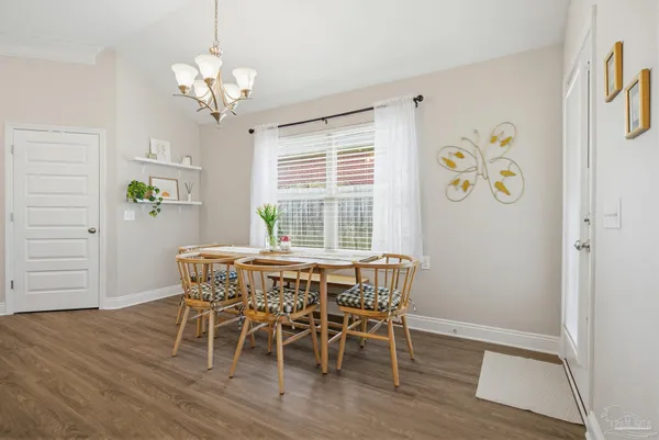 a dining room with wooden floor and breakfast area