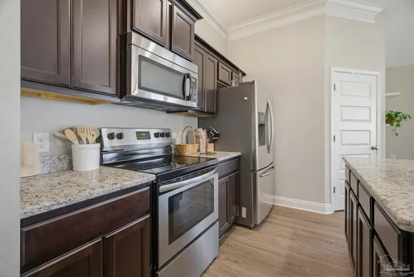 a kitchen with stainless steel appliances granite countertop a stove and a refrigerator