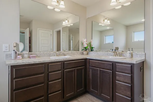 a bathroom with a sink double vanity and a mirror
