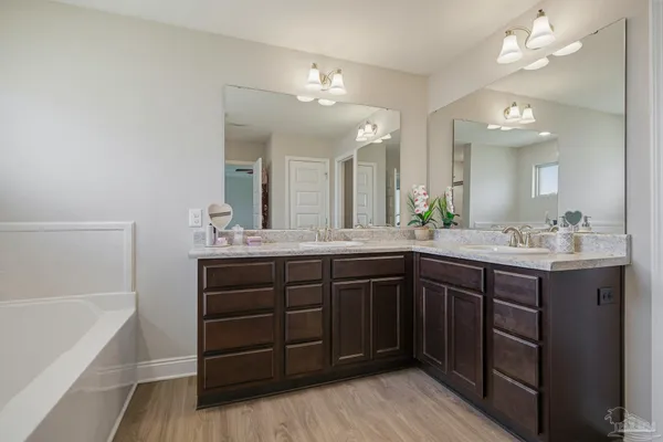 a bathroom with a sink vanity and bathtub