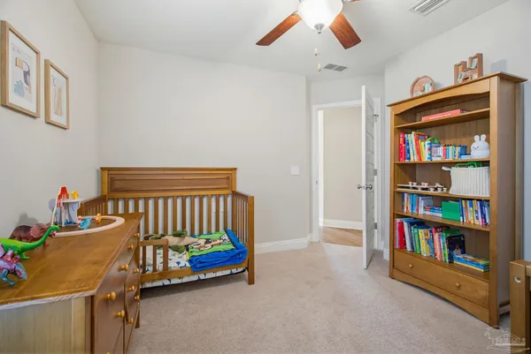 a bedroom with furniture and a book shelf