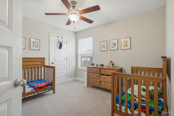 a bed room with furniture and a baby crib
