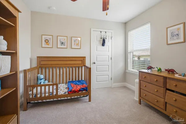 a bedroom with furniture and a window