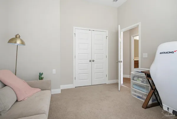 a view of a livingroom with workspace and a window