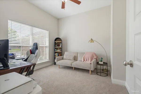an empty room with wooden floor closet and windows