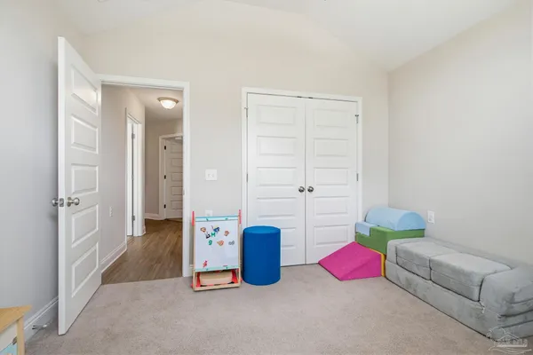 a view of a bedroom with baby crib and a window