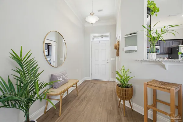 a view of a dining room with furniture and a potted plant
