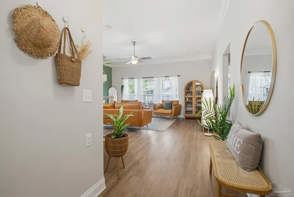 a living room with furniture flowerpot and wooden floor