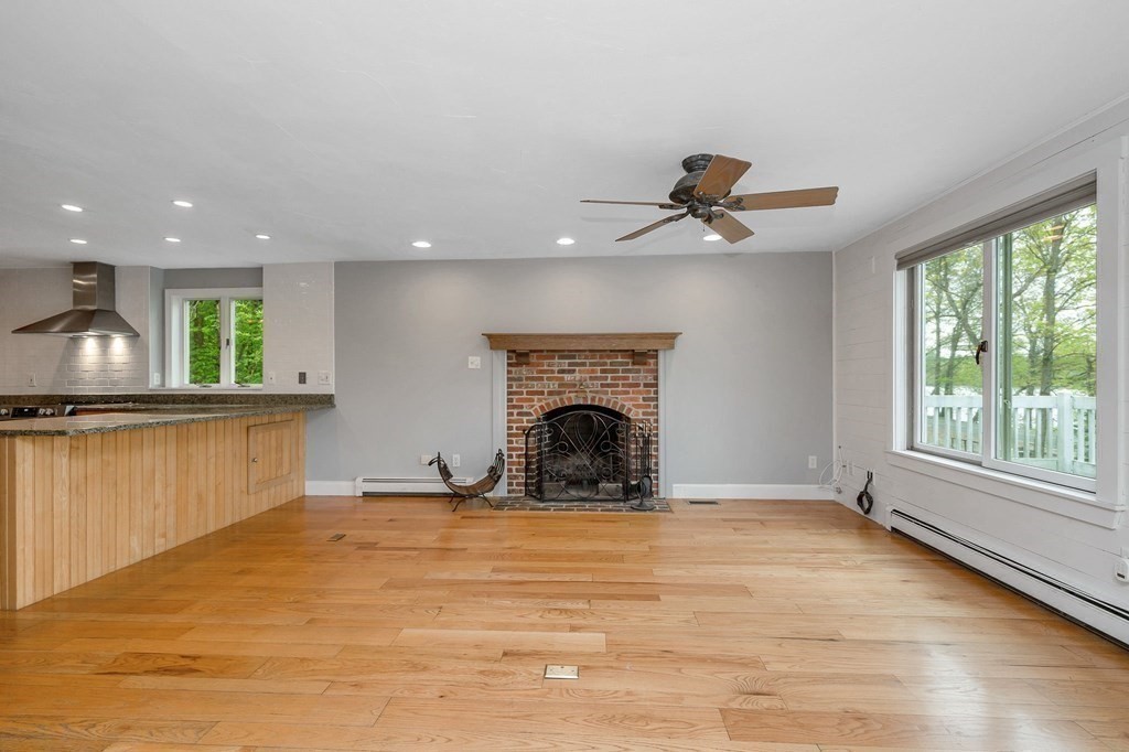 149 Pleasant Valley Road Amesbury, MA 01913 - Photo 11 of 42 a view of a livingroom with a fireplace and window