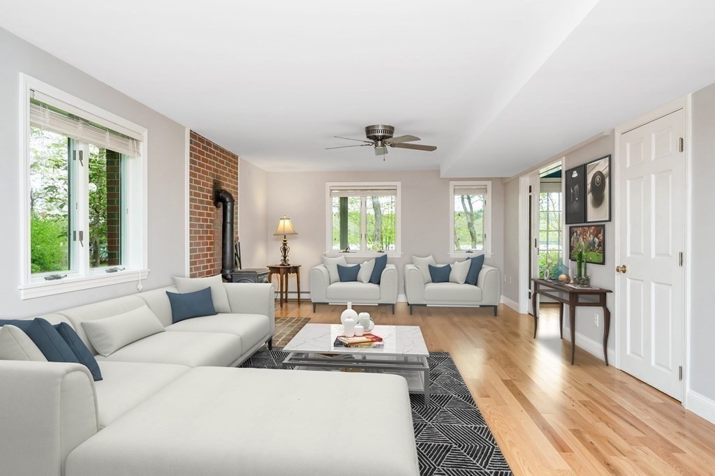 149 Pleasant Valley Road Amesbury, MA 01913 - Photo 13 of 42 a living room with furniture wooden floor and a large window