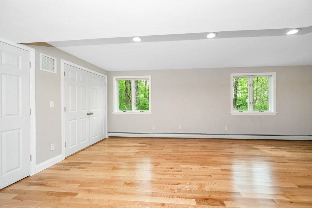 149 Pleasant Valley Road Amesbury, MA 01913 - Photo 14 of 42 an empty room with wooden floor and windows