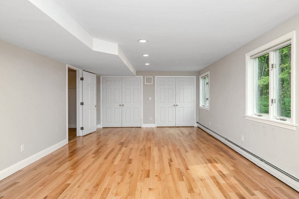 149 Pleasant Valley Road Amesbury, MA 01913 - Photo 15 of 42 a view of empty room with wooden floor and fan
