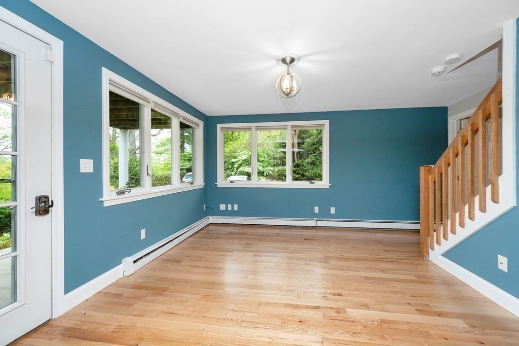 149 Pleasant Valley Road Amesbury, MA 01913 - Photo 17 of 42 a view of an empty room with wooden floor and a window