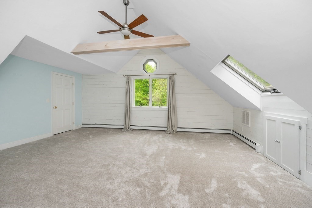 149 Pleasant Valley Road Amesbury, MA 01913 - Photo 19 of 42 an empty room with windows and fan