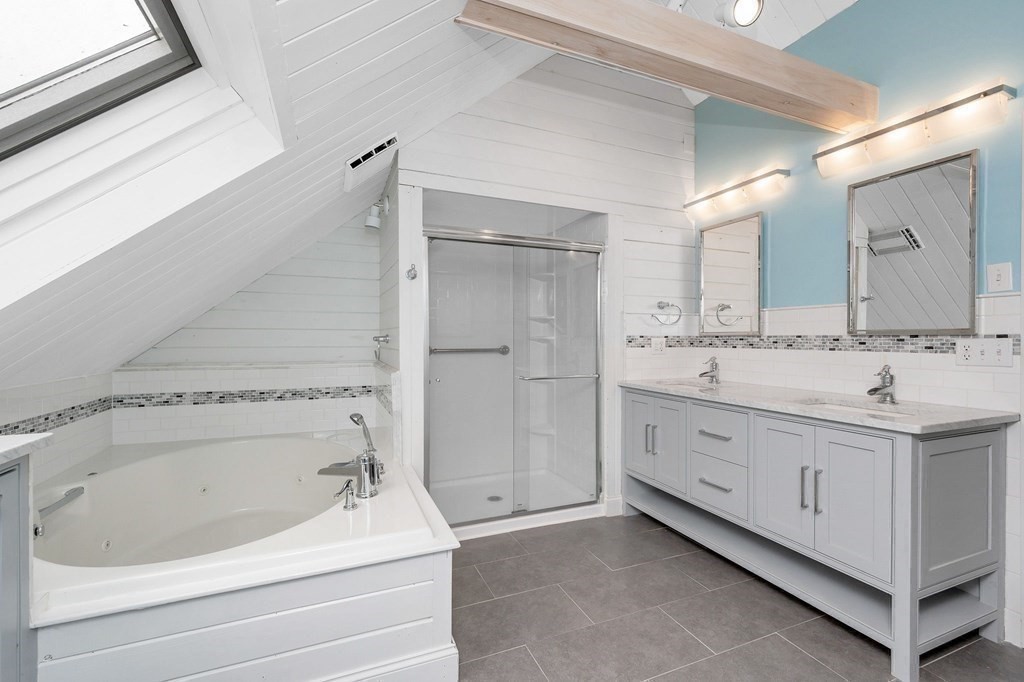 149 Pleasant Valley Road Amesbury, MA 01913 - Photo 23 of 42 a bathroom with a sink and a bathtub