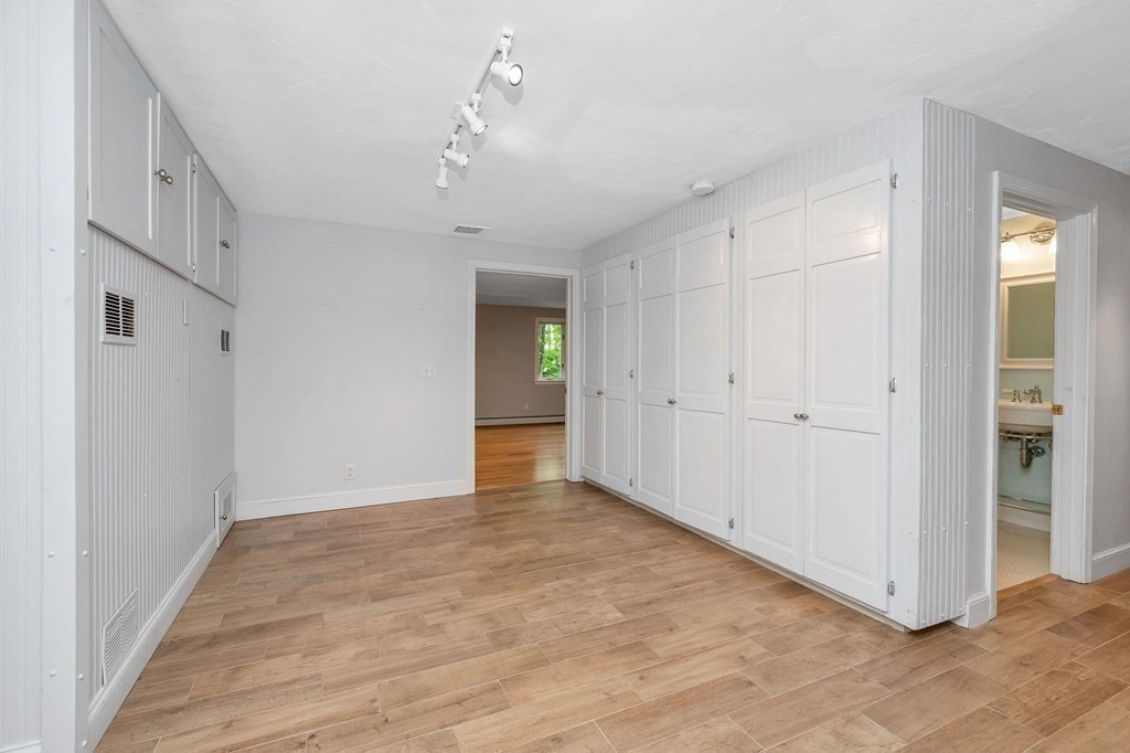 149 Pleasant Valley Road Amesbury, MA 01913 - Photo 33 of 42 a view of an empty room with wooden floor
