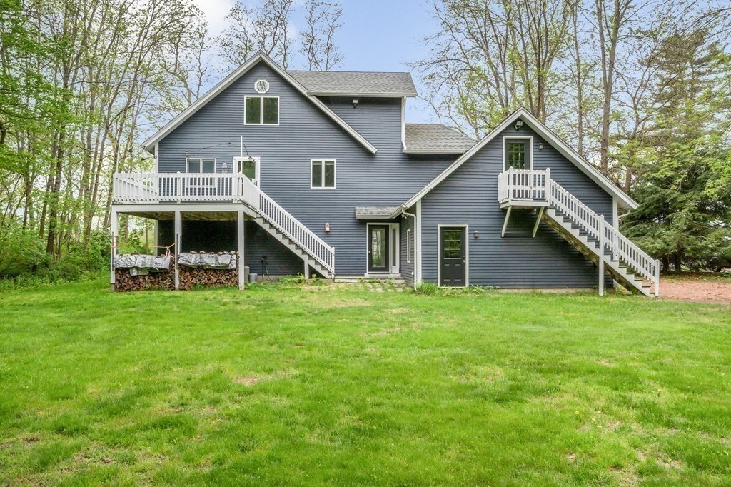 149 Pleasant Valley Road Amesbury, MA 01913 - Photo 39 of 42 a view of a house with backyard and garden