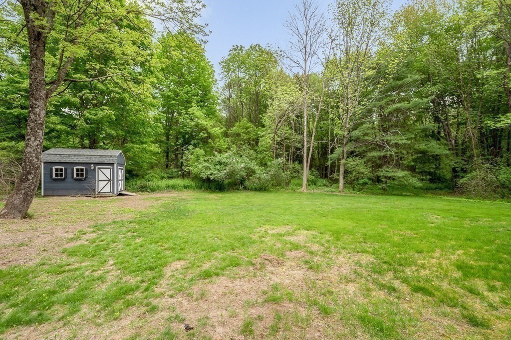 149 Pleasant Valley Road Amesbury, MA 01913 - Photo 40 of 42 a view of a house with a yard