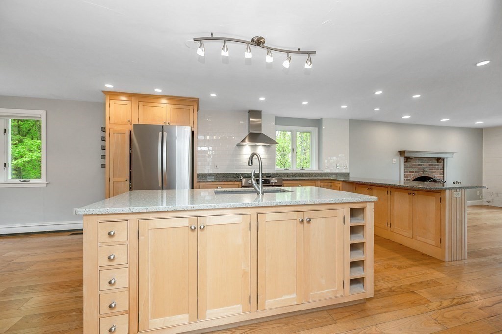 149 Pleasant Valley Road Amesbury, MA 01913 - Photo 6 of 42 a large kitchen with cabinets and wooden floor
