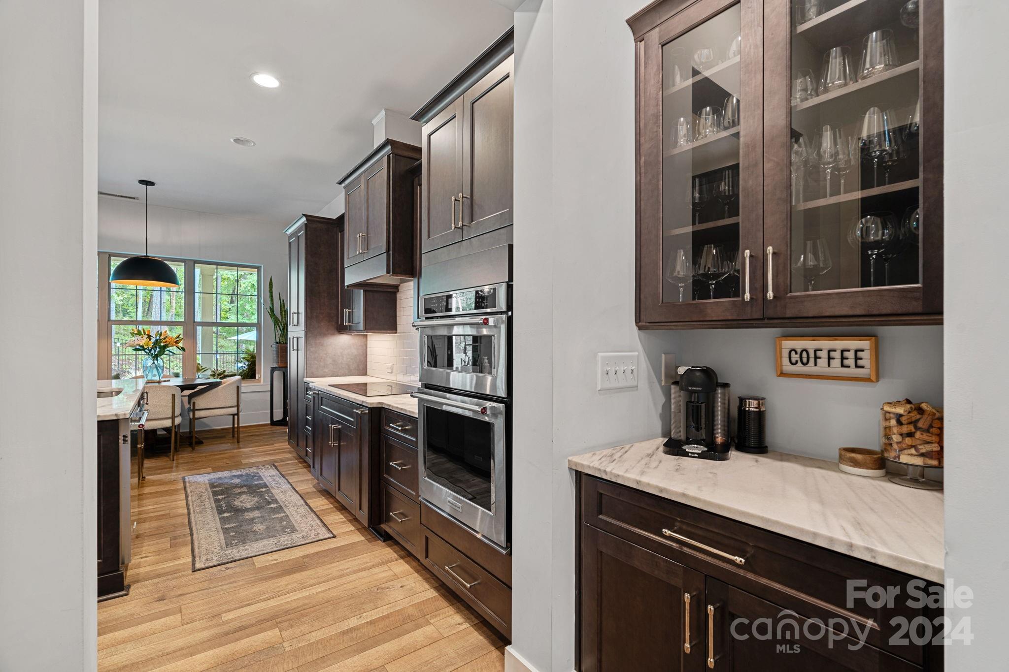 203 Webbed Foot Road Mooresville, NC 28117 - Photo 11 of 34 a kitchen with stainless steel appliances granite countertop a stove a sink and a refrigerator