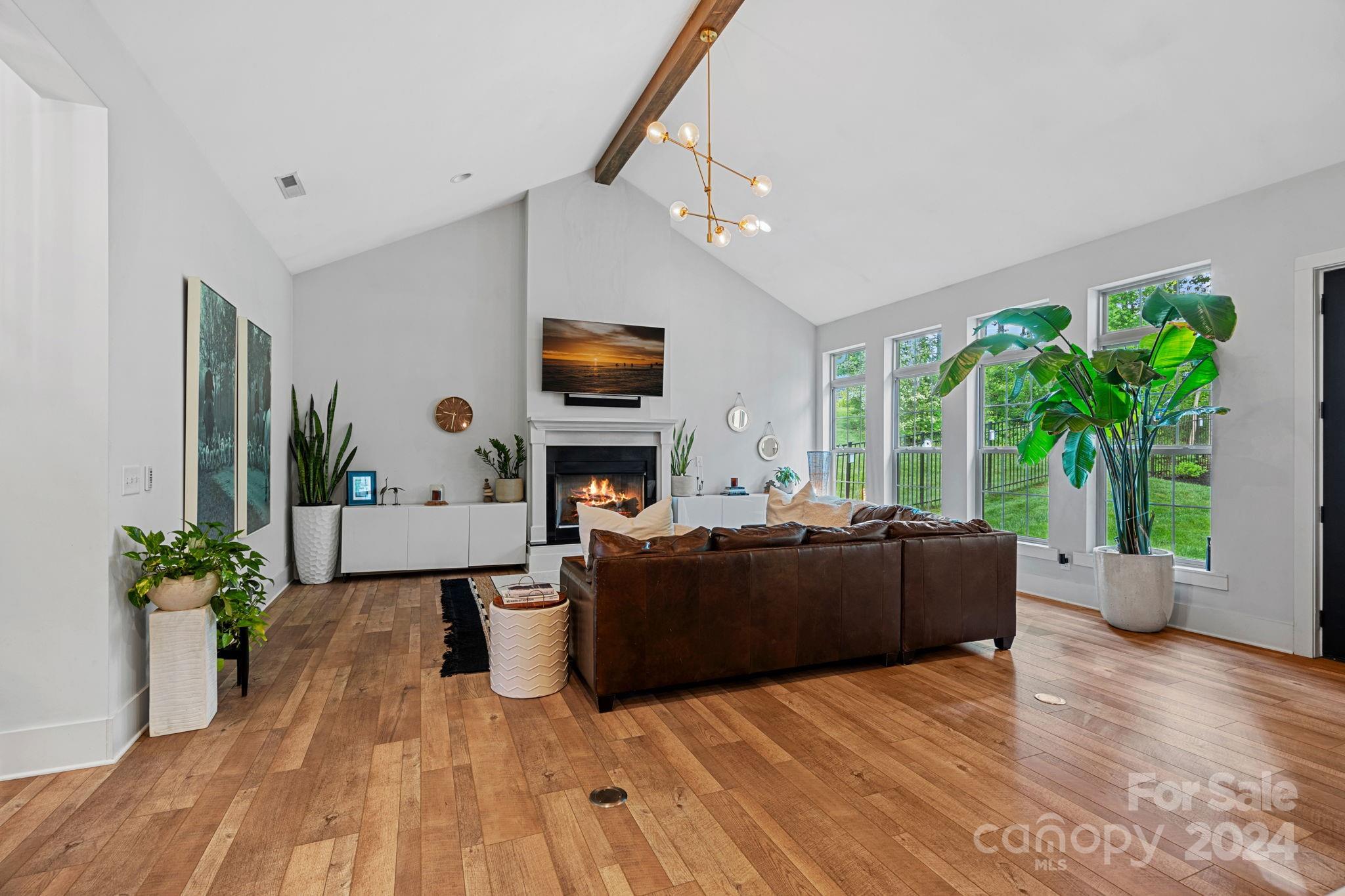 203 Webbed Foot Road Mooresville, NC 28117 - Photo 16 of 34 a living room with furniture a large window and a flat screen tv