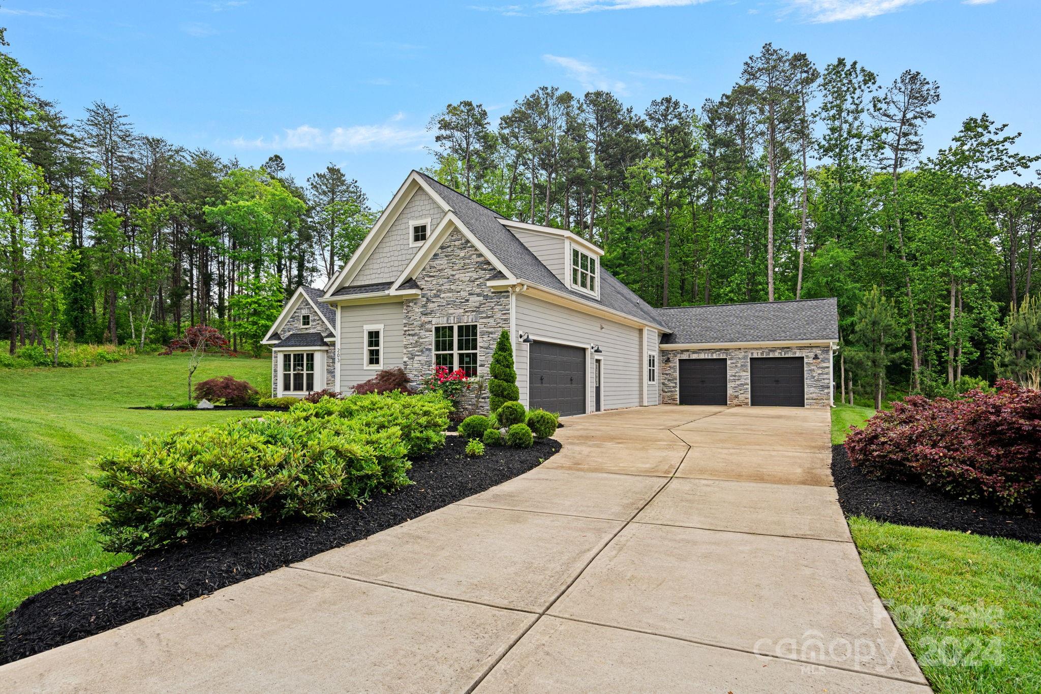 203 Webbed Foot Road Mooresville, NC 28117 - Photo 2 of 34 a front view of a house with a garden