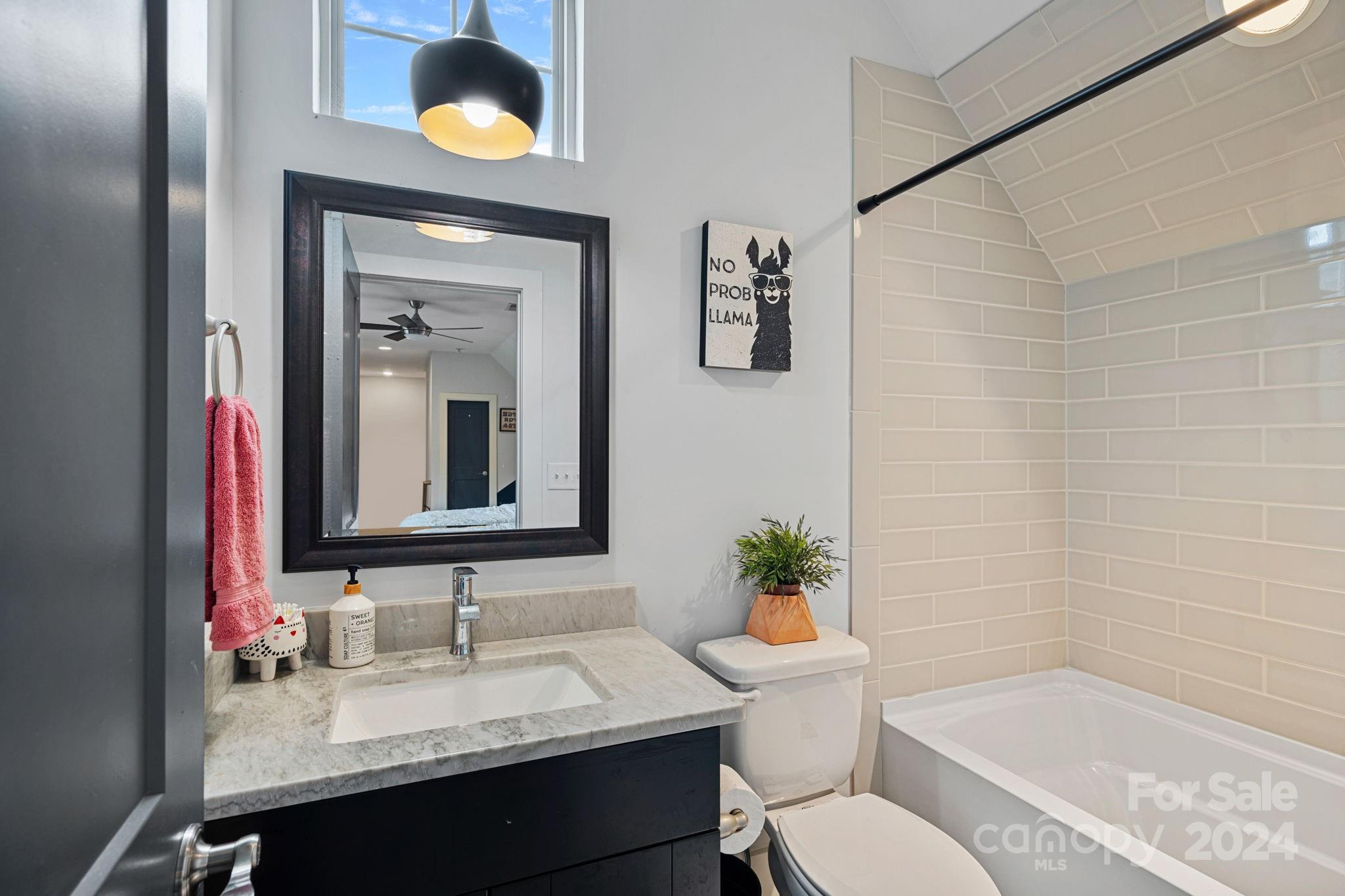 203 Webbed Foot Road Mooresville, NC 28117 - Photo 23 of 34 a bathroom with a granite countertop sink toilet a mirror and shower