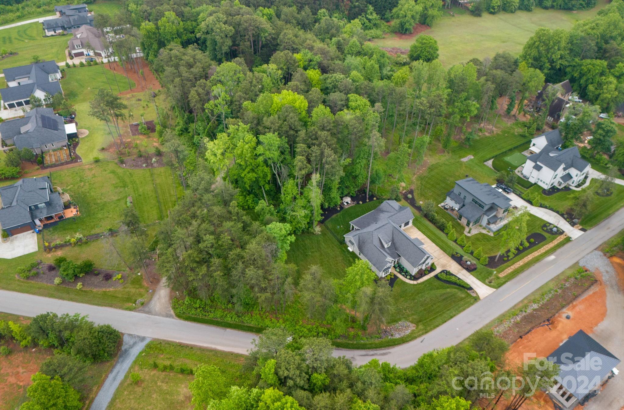 203 Webbed Foot Road Mooresville, NC 28117 - Photo 32 of 34 an aerial view of a house with a garden and lake view