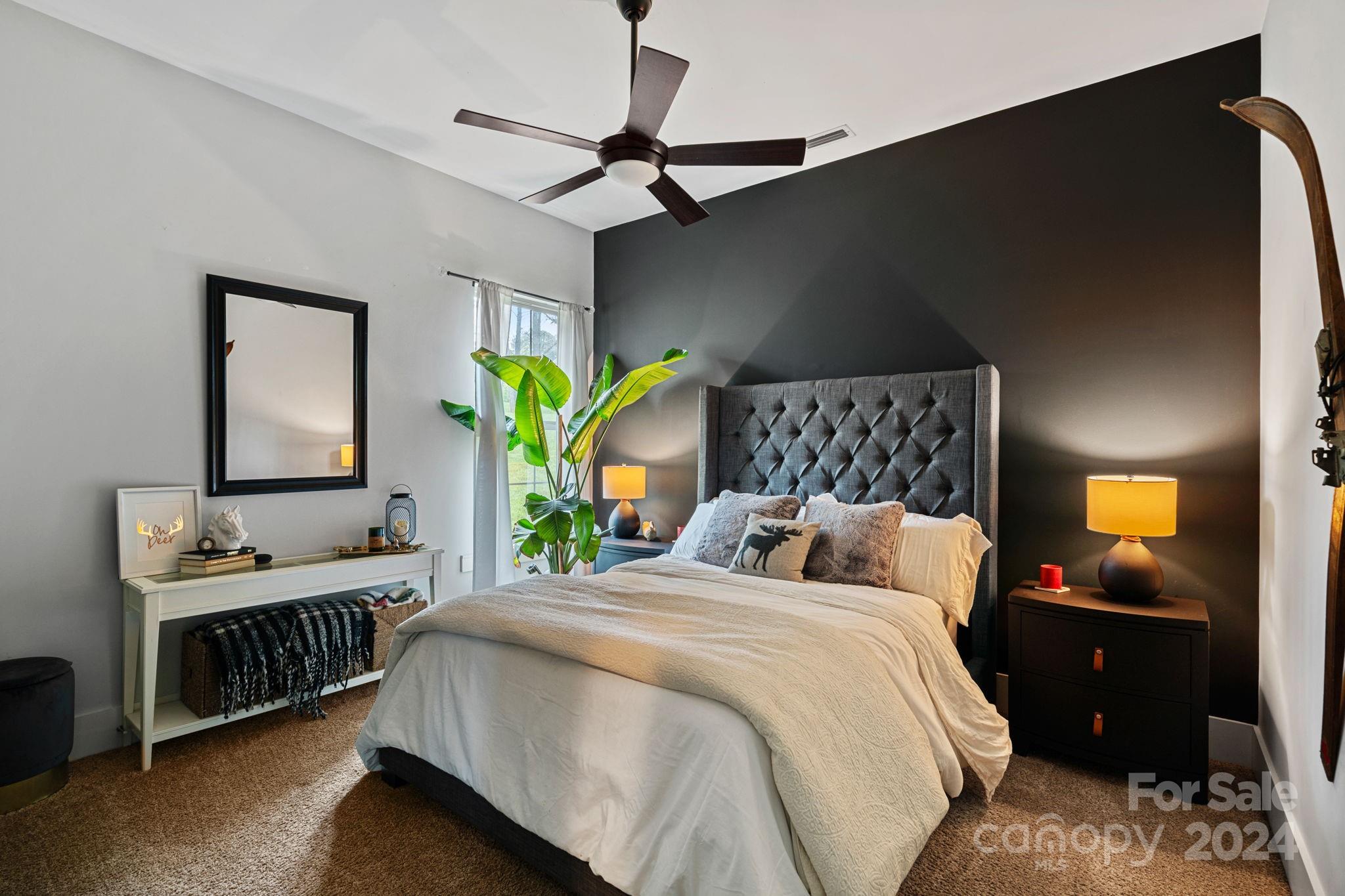 203 Webbed Foot Road Mooresville, NC 28117 - Photo 10 of 34 a bedroom with a bed and a flat tv screen on dresser