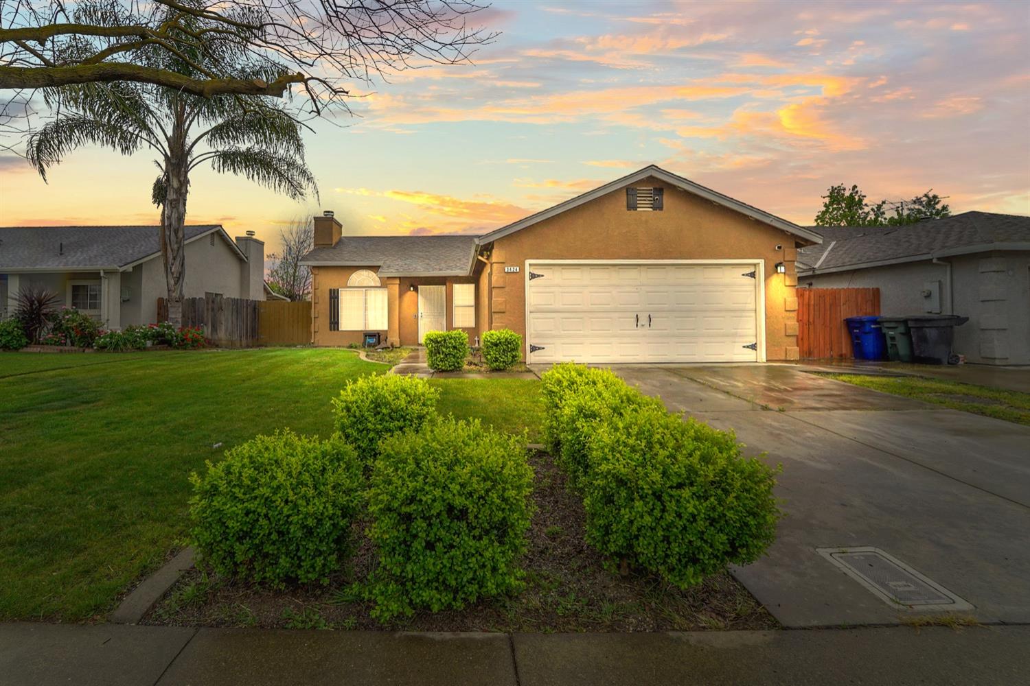 3424 Penny Lane Modesto, CA 95354 - Photo 1 of 1 a front view of a house with a yard and garage