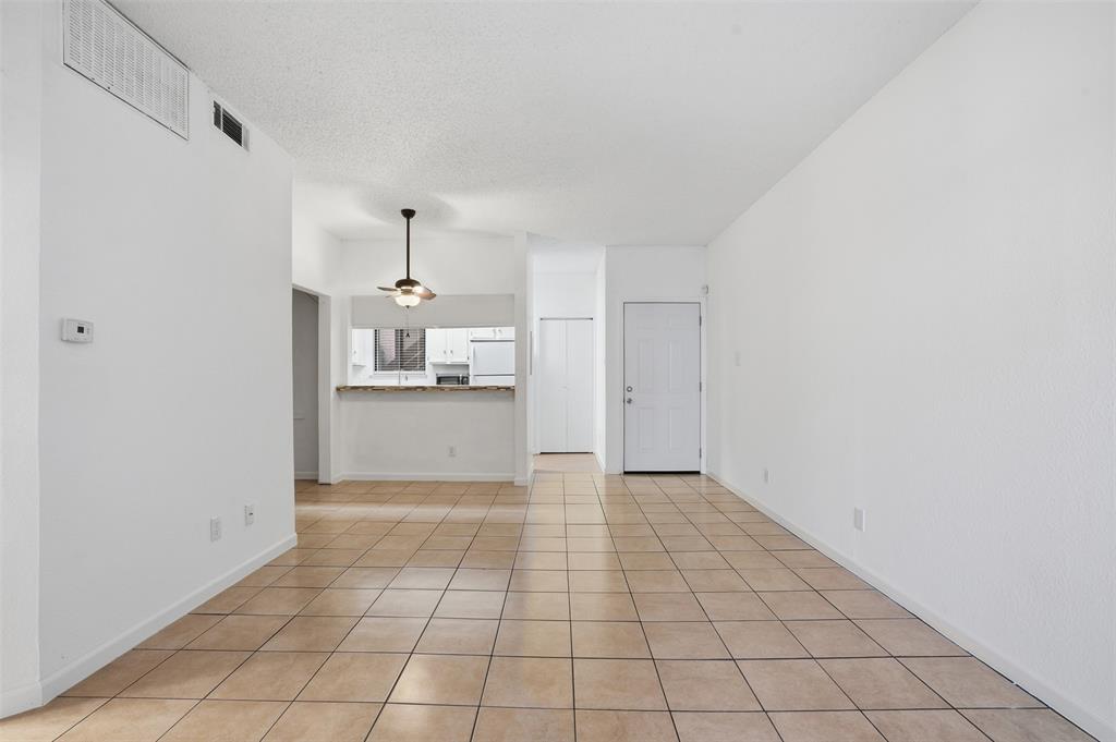 5550 Spring Valley Road, Unit F14 Dallas, TX 75254 - Photo 5 of 15 a view of a kitchen with a sink and a refrigerator