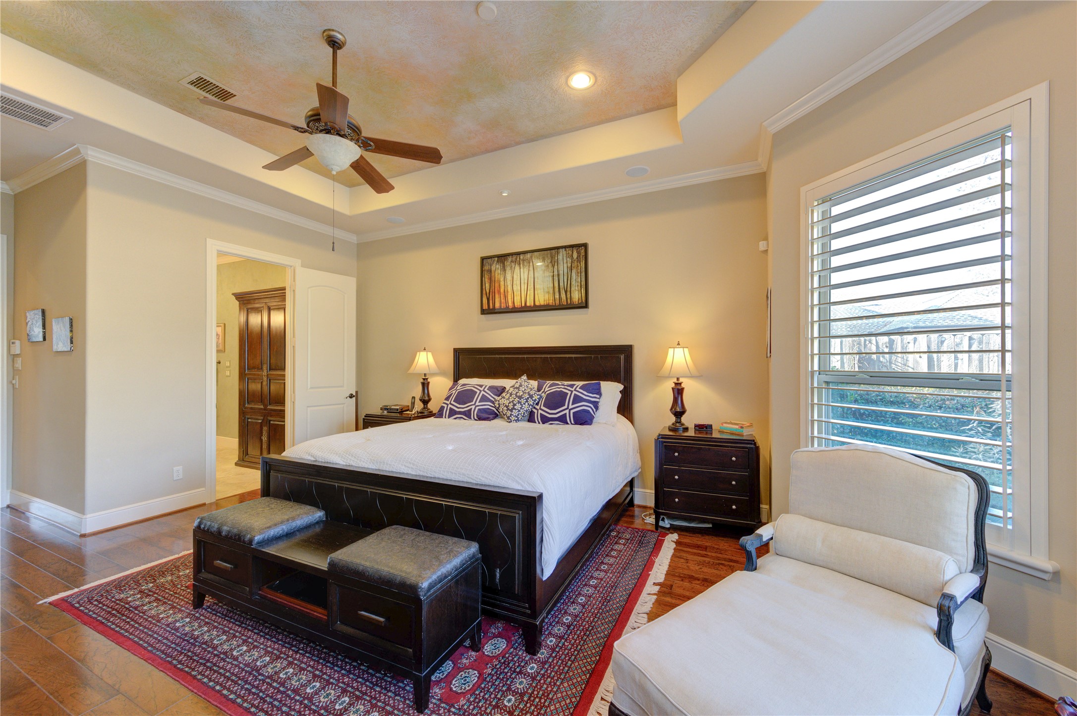 16618 Victoria Falls Lane Spring, TX 77379 - Photo 15 of 49 Luxurious master bedroom featuring elegant tray ceilings, hardwood floors, and ample natural light. Relax in style and comfort.